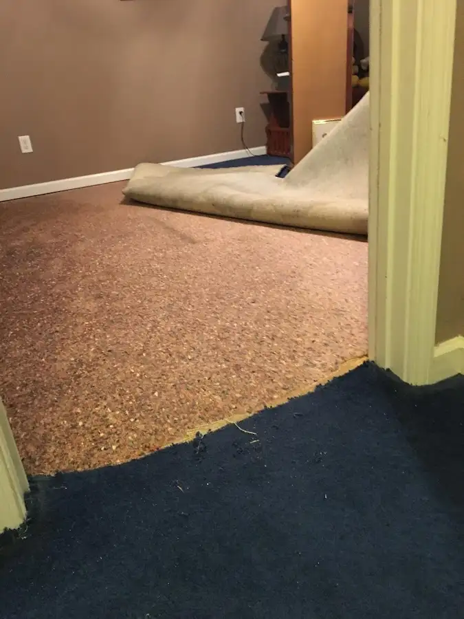 Carpet pad removal revealing water damage during Water Mitigation Services in Carmichael
